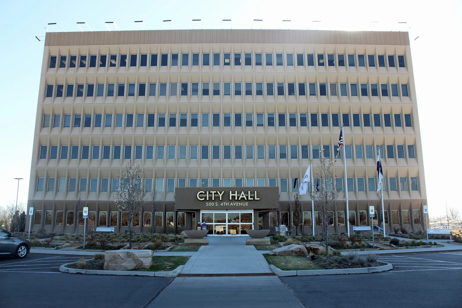 Brighton, Colorado City Hall, a multi-story building with flags out front