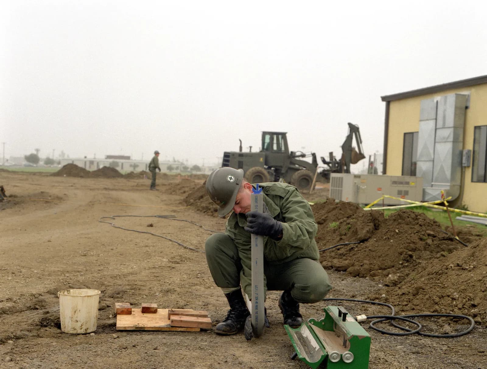 A U.S. Navy construction electrician works on electrical equipment