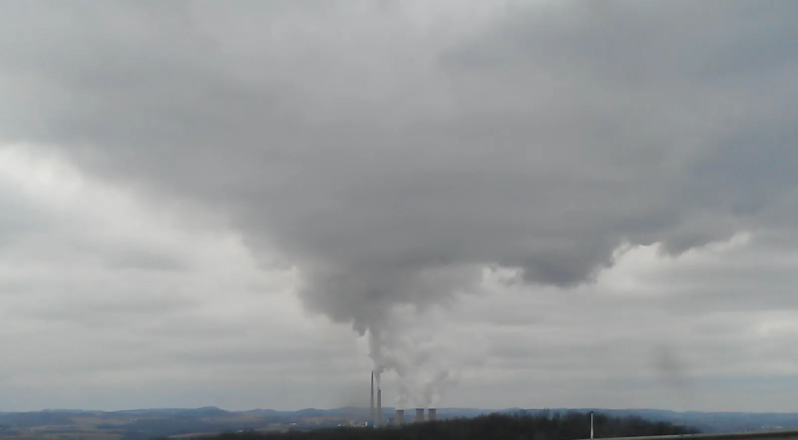 The Homer City Generating Station's stacks and cooling tower plume on a gray day